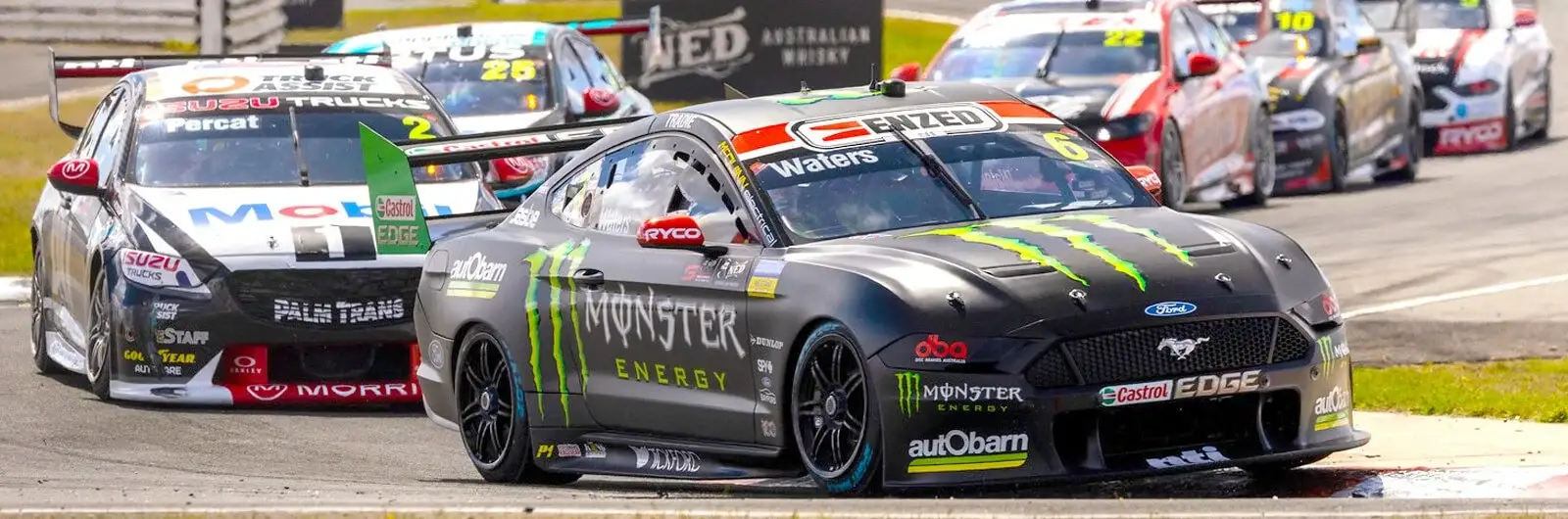 Monster Energy Ford Mustang Supercar leading a pack of race cars on a circuit
