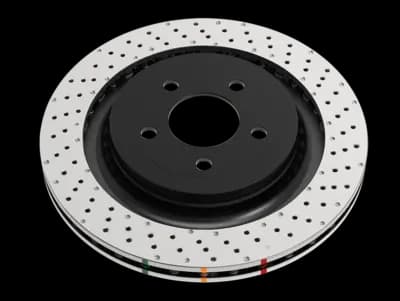 DBA 4000 Series XD brake rotor featuring non-directional cross-drilled holes and dimples on silver surface with black center hub and colored indicators
