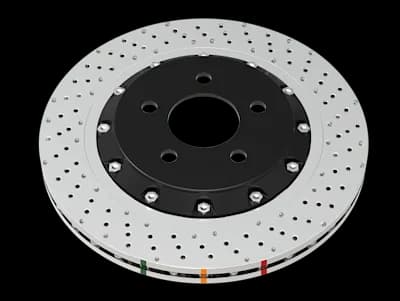 DBA 5000 Series XD brake rotor featuring non-directional cross-drilled holes and dimples on silver surface with black center hub and colored indicators