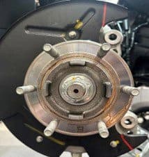 Step 2B: Completed clearance cut markings on backing plate showing precise modification areas for DBA caliper upgrade Backing plate with completed paint pen markings showing where material needs to be removed for proper DBA 6-pot caliper fitment