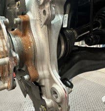 Step 4D: Final modified OE hub casting with excess material removed providing necessary clearance for DBA caliper fitment Modified original equipment hub casting after excess material removal showing proper clearance for DBA caliper installation